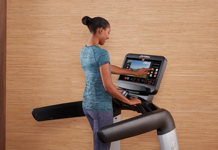 Life Fitness Platinum Club Series Treadmill with Discover SE3HD Console woman using