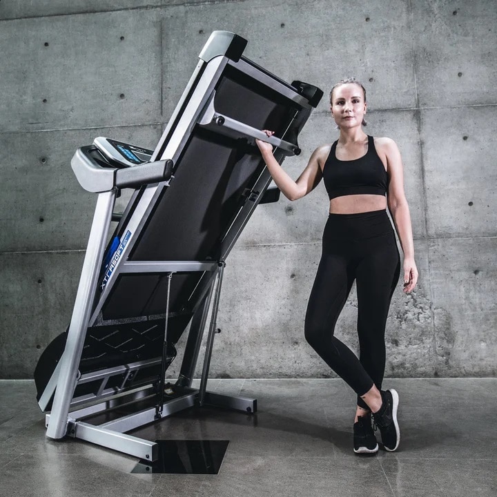 Xterra TRX 3500 Folding Treadmill - folded with female model