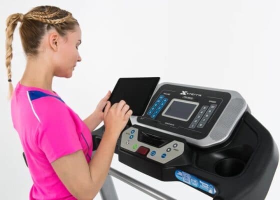 Xterra TRX 3500 Folding Treadmill - female model with tablet