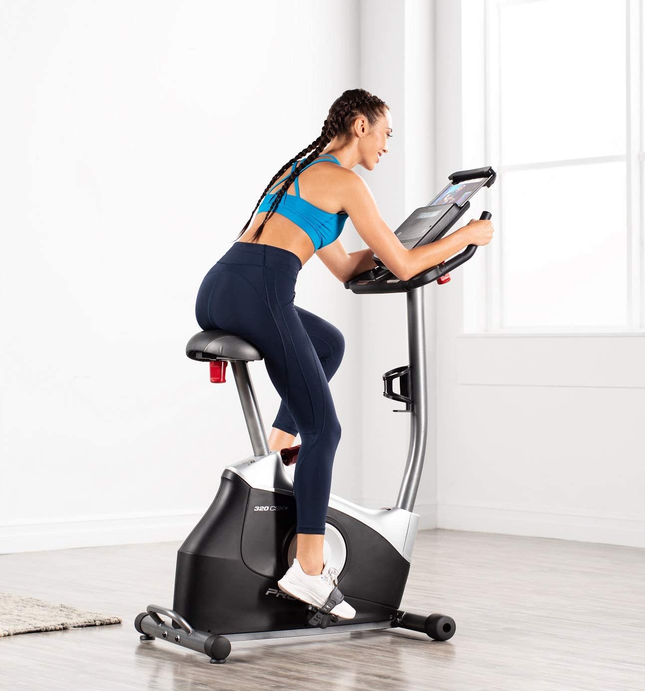 Proform 320 CSX+ Exercise Bike - with a female model cycling