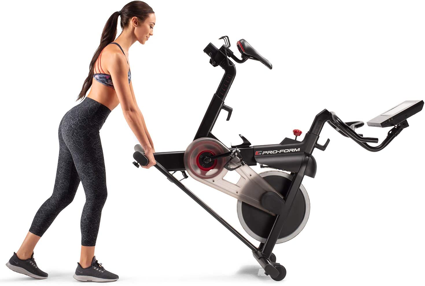 Proform Smart Power 10.0 Exercise Bike - with a female model moving it