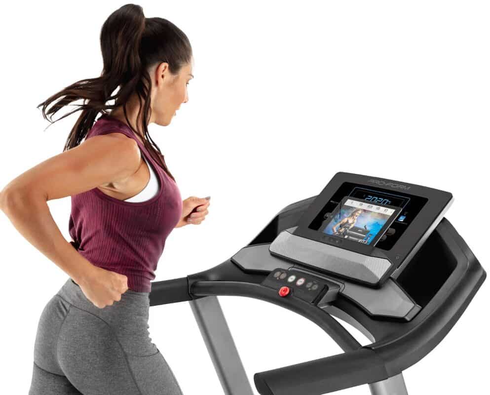 Proform Sport 6.0 folding treadmill with a female model running - close up image