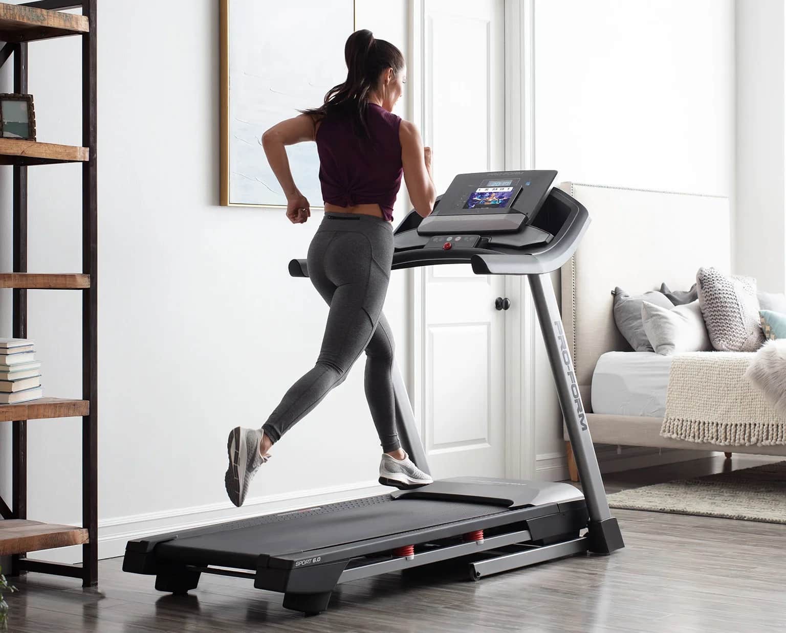 Proform Sport 6.0 folding treadmill - with a female model running on the machine