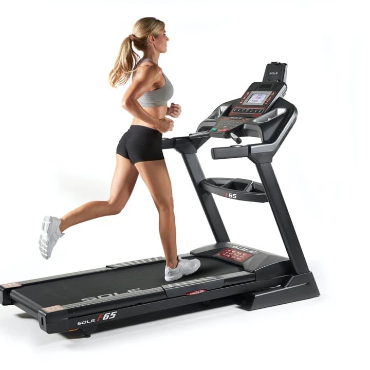 Sole F65 Folding Treadmill with a female model running 