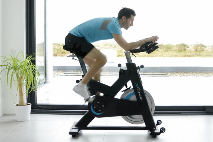 JTX Cyclo Studio Commercial Indoor Training Bike - with a male model exercising
