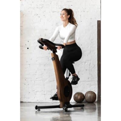 Nohrd Upright Exercise Bike - with a female model