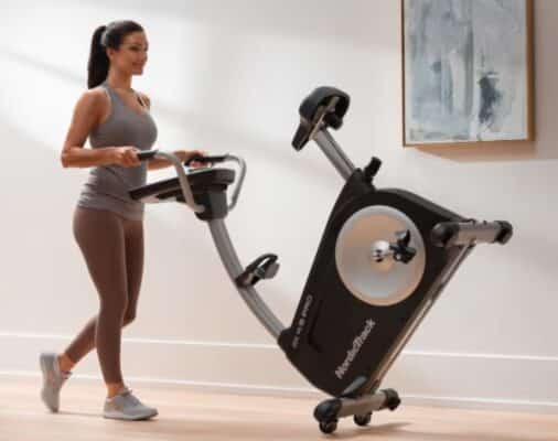 NordicTrack GX 4.5 Pro Exercise Bike - with a female model moving the machine