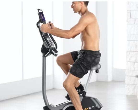 Nordictrack GX 2.7 U Exercise Bike - with a male model cycling 