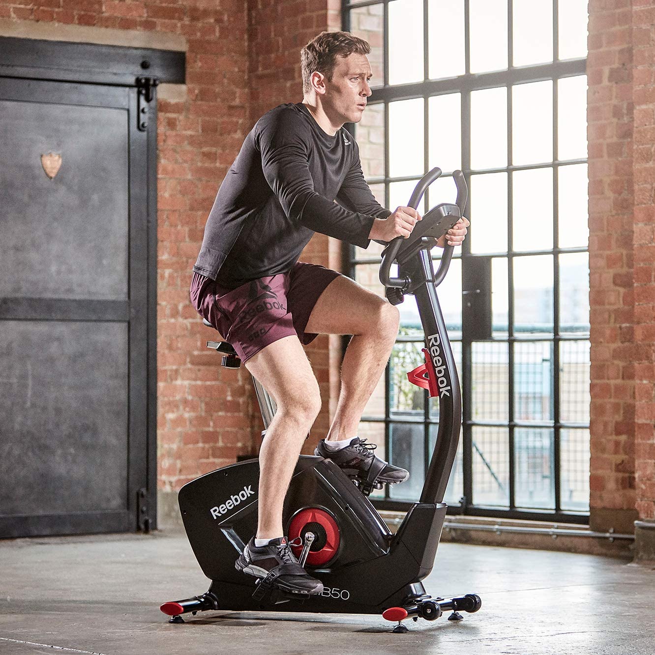 Reebok Exercise Bike GB50 - with a male model  cycling 