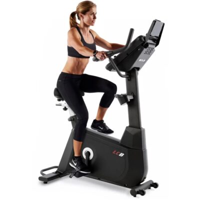 Sole LCB Upright Exercise Bike - with a female model cycling