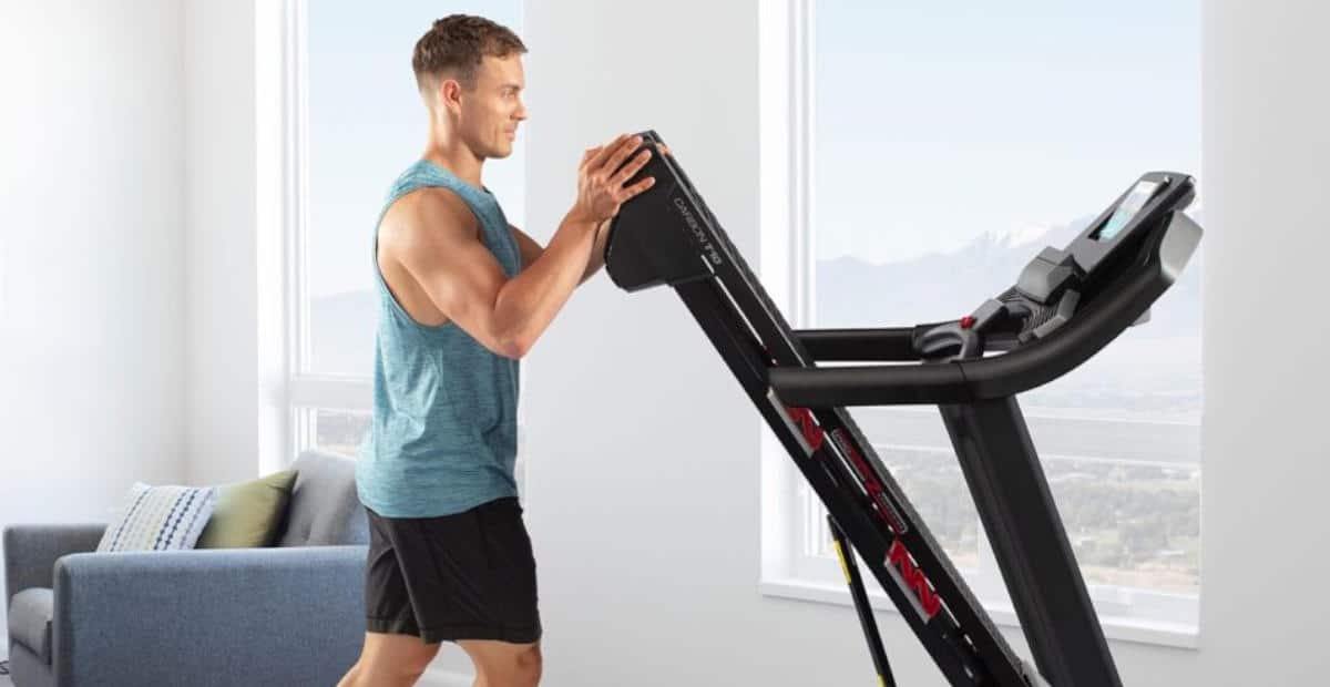 A man folding a treadmill