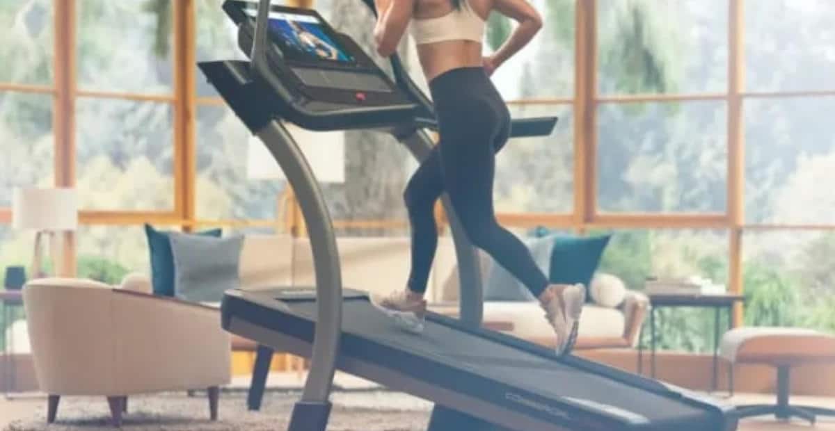 A woman running on an inclined treadmill 