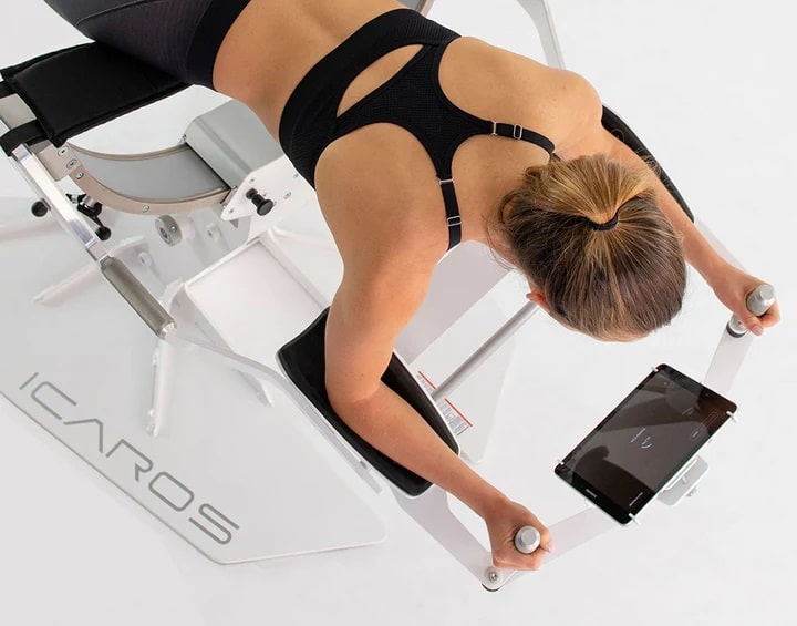 ICAROS Pro Commercial  Virtual Reality Fitness Equipment - with a female model using a tablet 