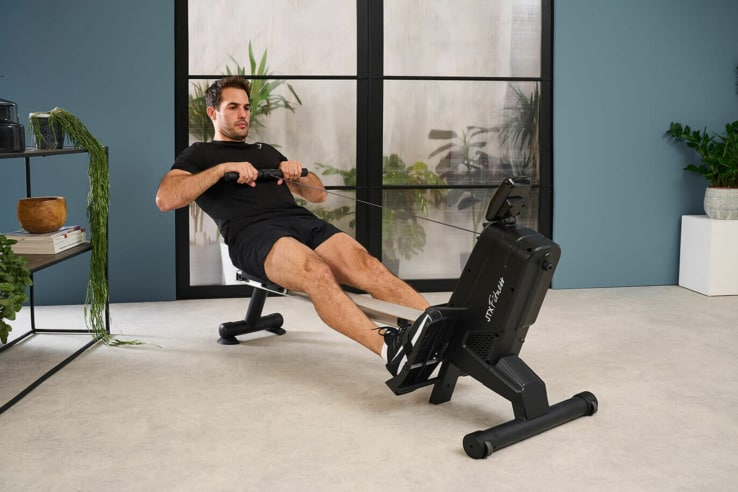 JTX Surge Compact Rowing Machine - with a male model 