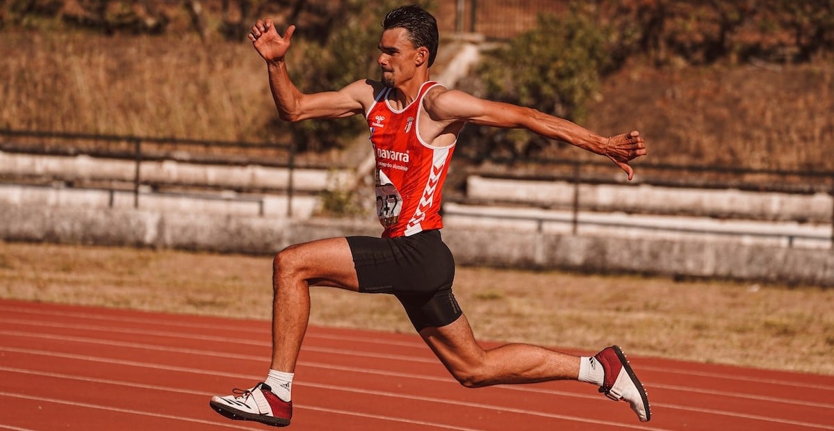 A man running on a track field 