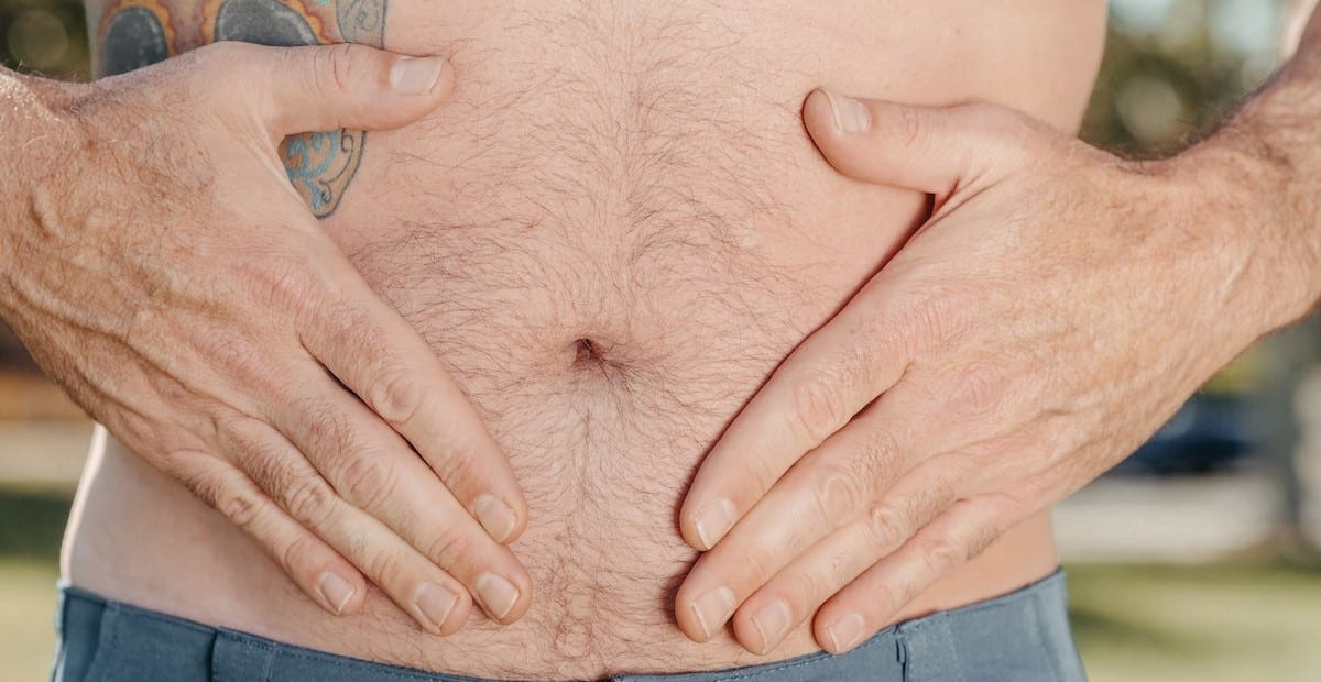 A Person Holding his Stomach
