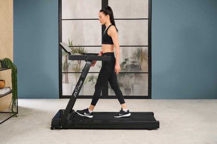 JTX Slim-line Flat Fold-away Treadmill with a female model exercising 