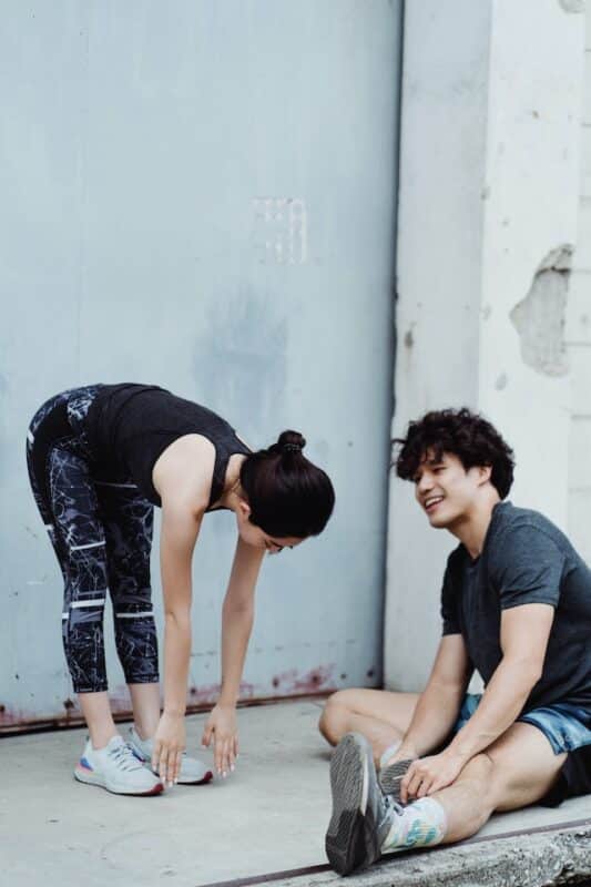 A man and a woman stretching 