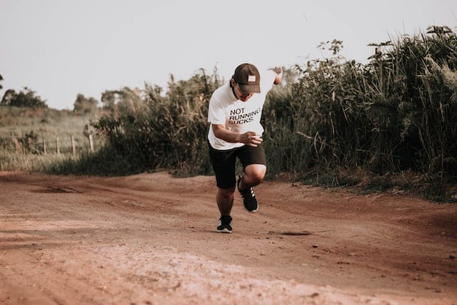 Man Running on Dirt Road
